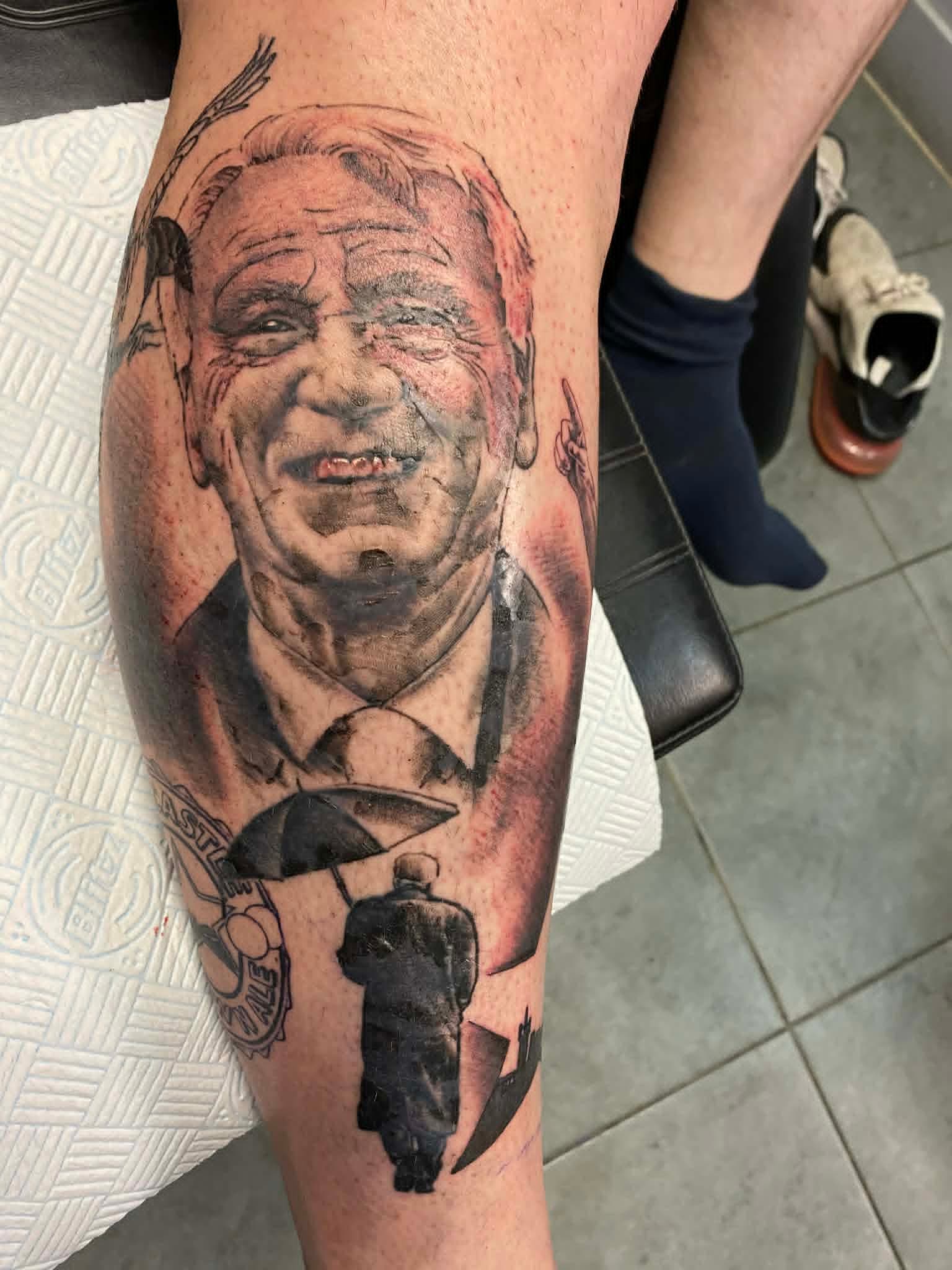 Black and grey realism Bobby Robson Newcastle United portrait calf tattoo by John Quinn at Tattoo Zone, tattoos Newcastle.